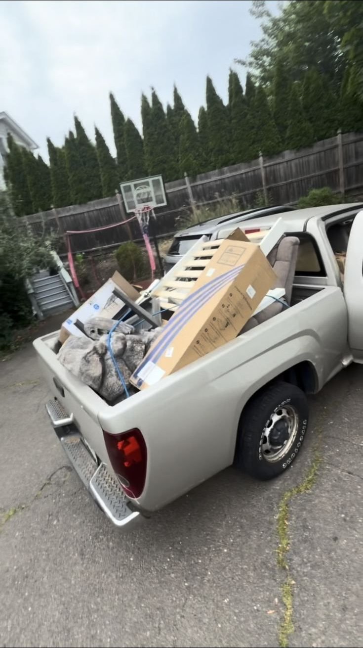 Truck bed loaded with furniture and boxes removed during a job