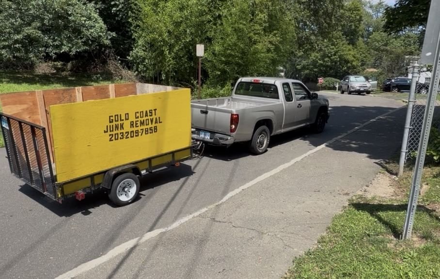 Gold Coast Junk Removal trailer and truck on a Fairfield County street